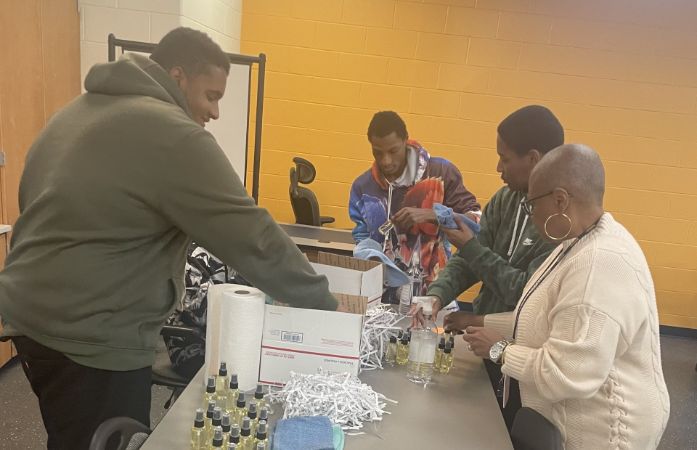  Students and staff packaging oil